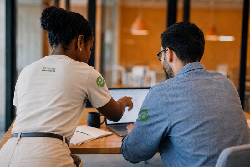 GreenCycle Environmental account experts reviewing service details together